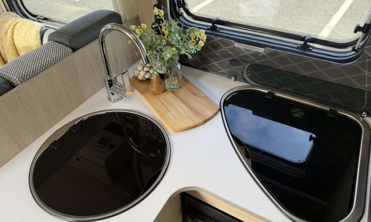 Auto-Trail F74 interior view showing the stove top and sink in the kitchen.