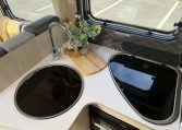 Auto-Trail F74 interior view showing the stove top and sink in the kitchen.