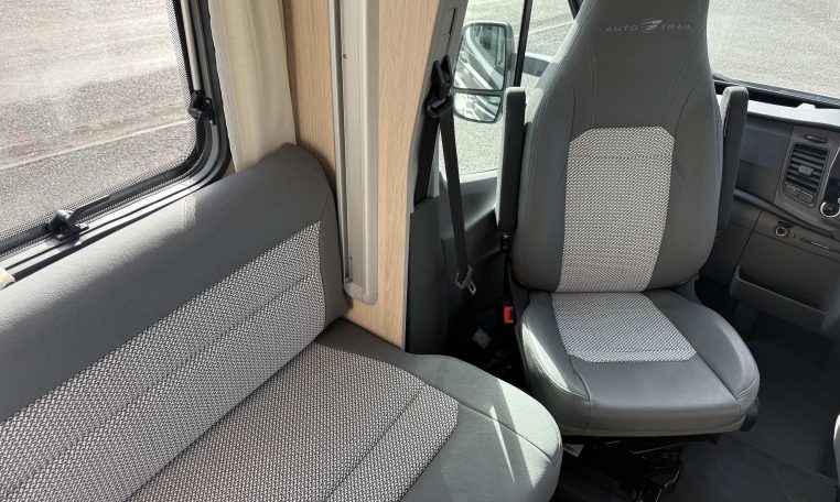 Auto-Trail F74 interior view showing the captain swivel chair with leatherette upholstery.