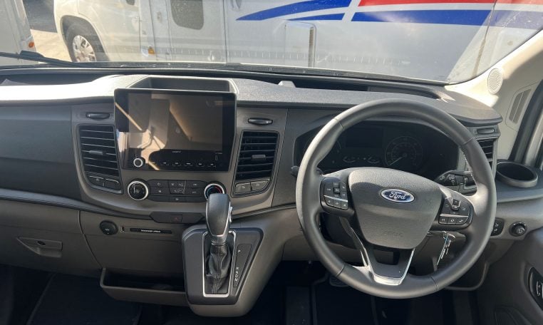 2024 Auto-Trail F-Line F62 motorhome interior view of the cab area showing the steering wheel and dashboard.