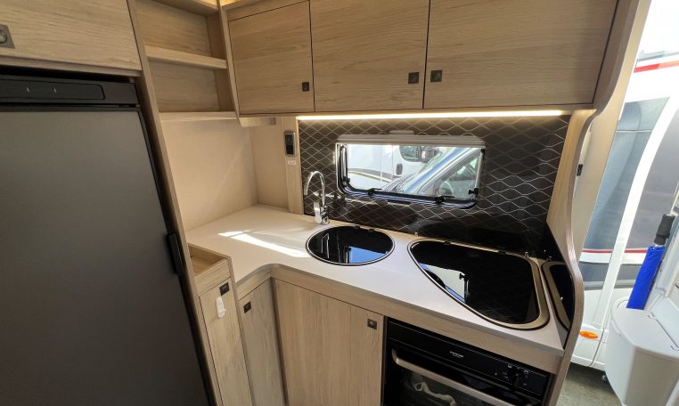 2024 Auto-Trail F-Line F62 motorhome interior view of the kitchen with stove top, oven and grill.