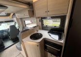 Interior view of the Auto-Trail F-Line F70 motorhome kitchen with sink, hob, and compact layout.