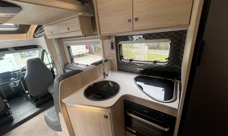 Interior view of the Auto-Trail F-Line F70 motorhome kitchen with sink, hob, and compact layout.