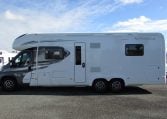 Side view of an Auto-Trail Frontier Comanche motorhome showing the habitation door and camper exterior.