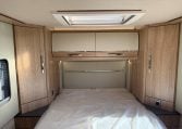2024 Auto-Trail Frontier Comanche interior showcasing the rear island bed and overhead storage.
