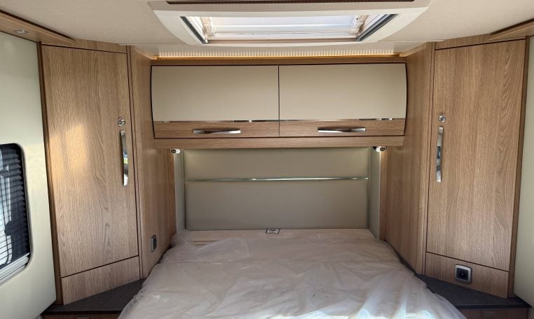 2024 Auto-Trail Frontier Comanche interior showcasing the rear island bed and overhead storage.