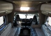 2024 Auto-Trail Frontier Comanche motorhome interior view showing the front lounge and dining overhead storage.