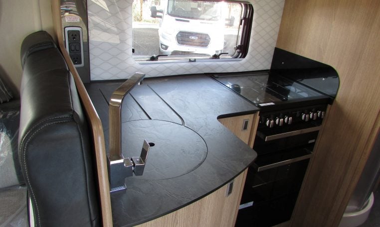 2024 Auto-Trail Frontier Comanche motorhome interior view showing the kitchen with hob and oven.