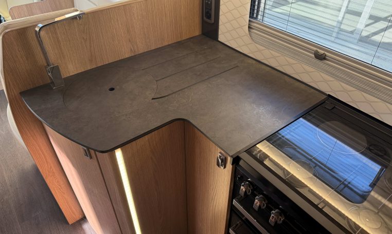 2024 Auto-Trail Frontier Comanche interior showcasing the cover over the kitchen sink.