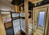 2024 Auto-Trail Frontier Delaware motorhome interior showing the fridge and microwave in the kitchen.
