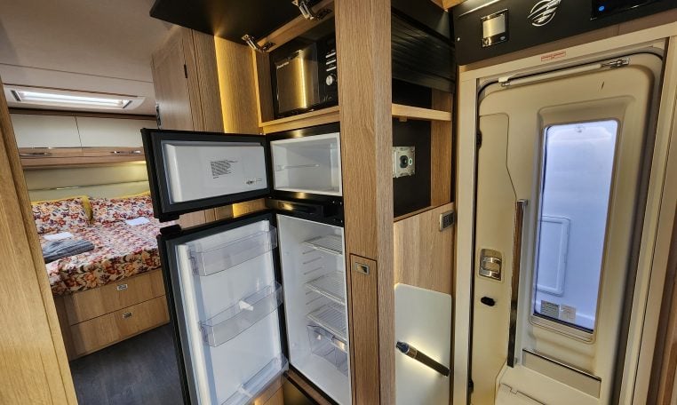 2024 Auto-Trail Frontier Delaware motorhome interior showing the fridge and microwave in the kitchen.