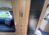 2024 Auto-Trail Frontier Scout interior view showing the wardrobe and fridge.