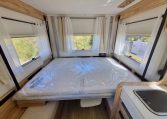 Fiat Ducato Pilote P696U interior showing the drop-down bed.