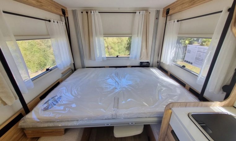 Fiat Ducato Pilote P696U interior showing the drop-down bed.