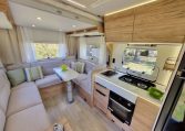 Fiat Ducato Pilote P696U interior showing the central kitchen with hob and oven.