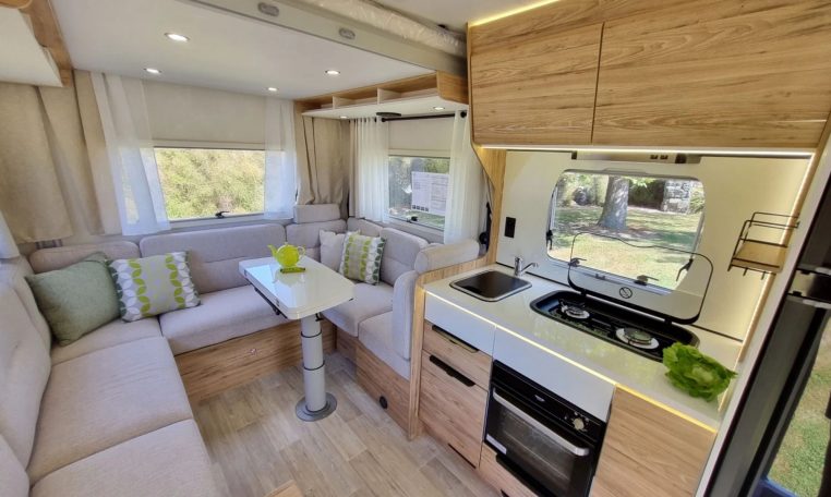 Fiat Ducato Pilote P696U interior showing the central kitchen with hob and oven.