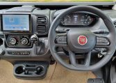 Fiat Ducato Pilote P696U interior showing the front cab with steering wheel and dashboard.