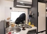 Interior view of the Roller Team Zefiro 665 motorhome kitchen with hob and compact layout.