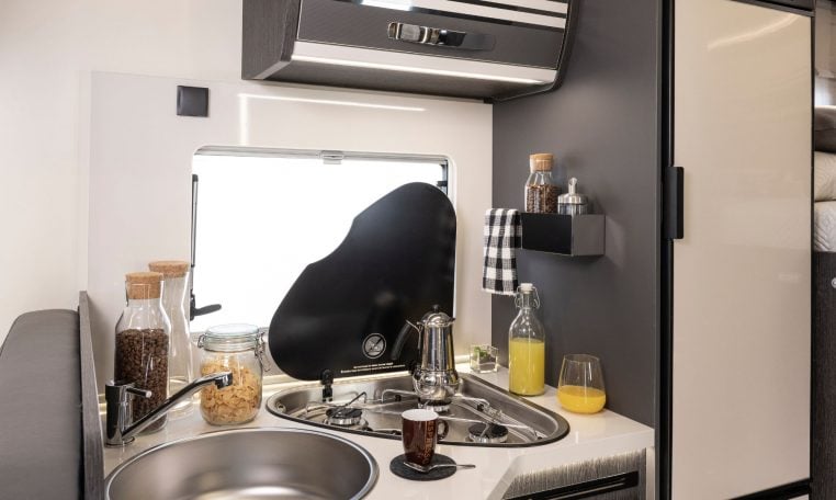 Interior view of the Roller Team Zefiro 665 motorhome kitchen with hob and compact layout.