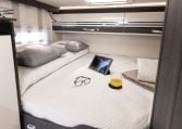 Rear Roller Team Zefiro 665 motorhome bed positioned above large garage provides elevated sleeping comfort, privacy and efficient space use max.