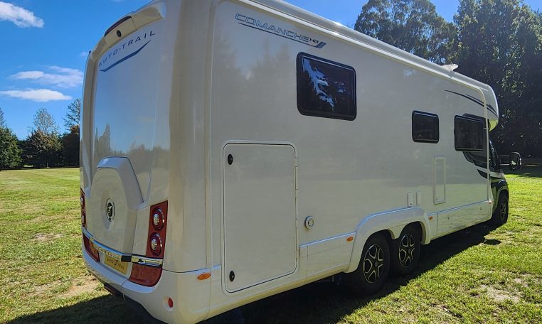 2025 Auto-Trail Comanche exterior showing the rear side and drivers' side of the motorhome.