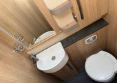 2025 Auto-Trail Frontier Comanche interior view of the toilet and handbasin in the bathroom.