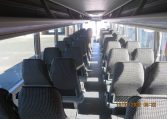 Overhead storage in a BCI Classmaster bus for passengers to place small bags and personal items.