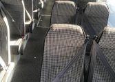 Passenger seats inside a BCI Classmaster bus arranged in rows along the aisle.
