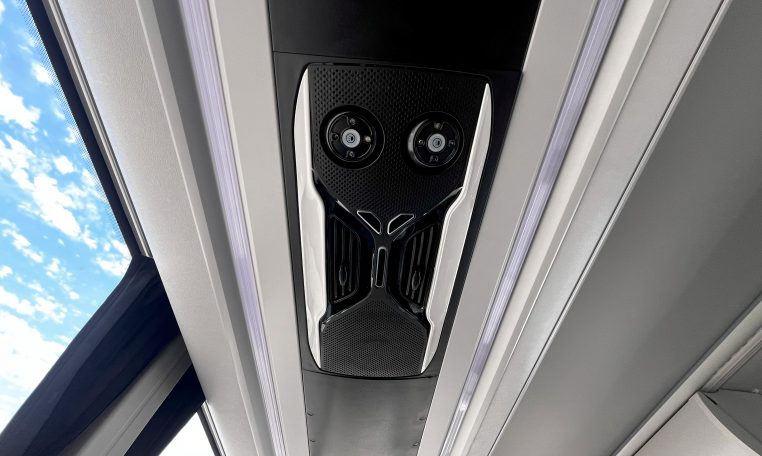 Overhead speakers in a BCI Volvo B13R bus providing audio announcements and entertainment for passengers.