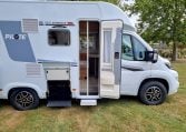 2025 Fiat Ducato Pilote P650C motorhome exterior view showing the open habitation door with fly screen.
