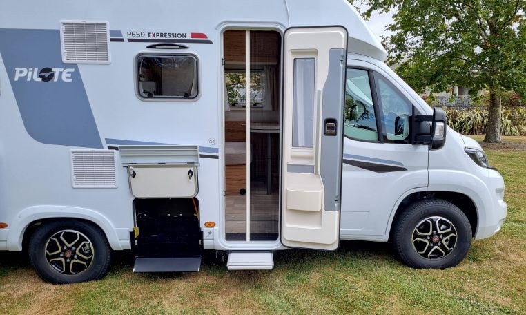 2025 Fiat Ducato Pilote P650C motorhome exterior view showing the open habitation door with fly screen.