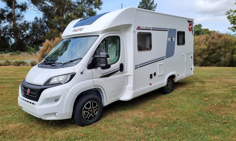 Exterior front and passenger side view of a Fiat Ducato Pilote P650C motorhome showing cab, headlights, side profile, and exterior design.