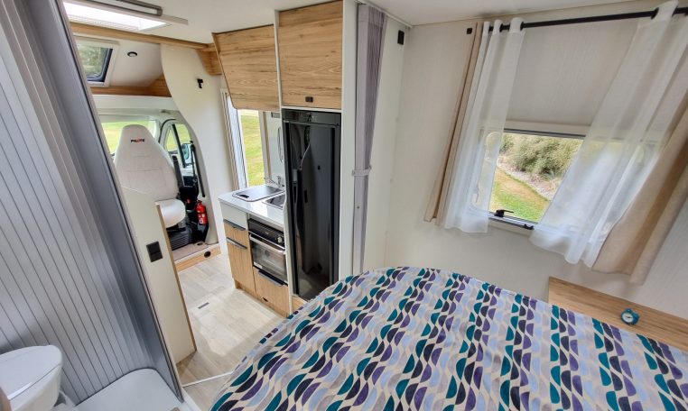 2025 Fiat Ducato Pilote P650C motorhome interior view showing the bedroom fabric curtains.