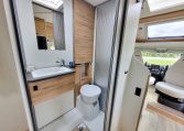 Interior view of the Pilote P650C motorhome bathroom with toilet and modern design.