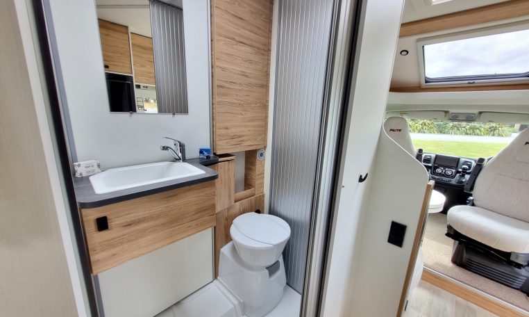 Interior view of the Pilote P650C motorhome bathroom with toilet and modern design.