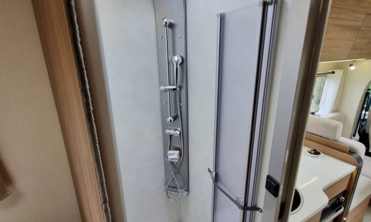 Fiat Ducato Pilote P740FC motorhome interior view showcasing the shower head in the shower.