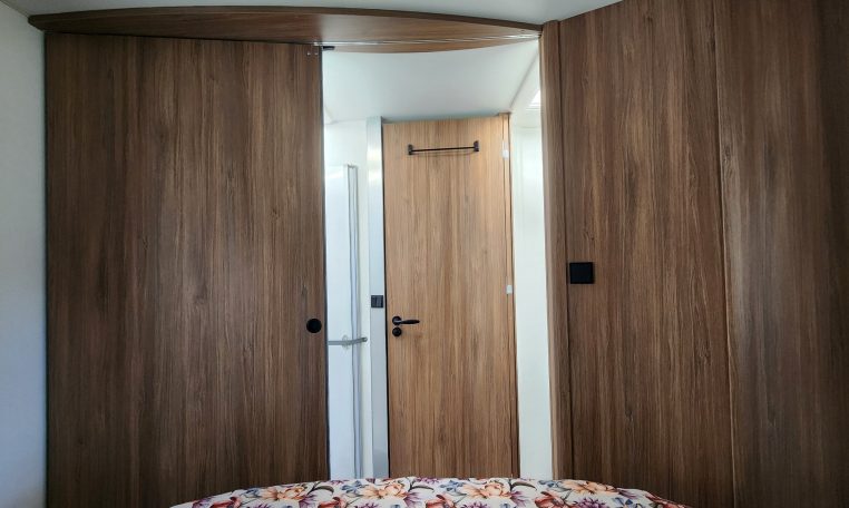 2025 Fiat Ducato Pilote P746FC interior view showing the closed bedroom door.