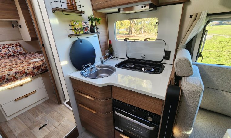 2025 Fiat Ducato Pilote P746FC interior view showing the compact motorhome kitchen setup.
