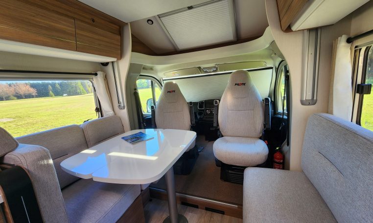 2025 Fiat Ducato Pilote P746FC interior view showing the spacious motorhome lounge and dining area.