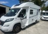Side view of a 2025 Pilote 650GJ motorhome showing the passenger door.