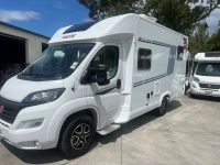 Side view of a 2025 Pilote 650GJ motorhome showing the passenger door.