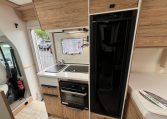 Compact 2025 Pilote 650GJ motorhome kitchen with fridge, oven and smart storage cupboards