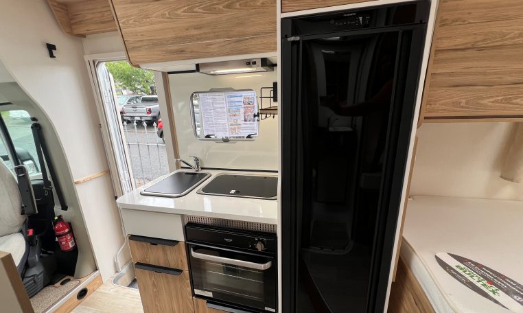 Compact 2025 Pilote 650GJ motorhome kitchen with fridge, oven and smart storage cupboards