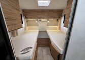 2025 Pilote 650GJ motorhome bedroom with twin single beds, central walkway and overhead storage for a spacious, comfortable layout.