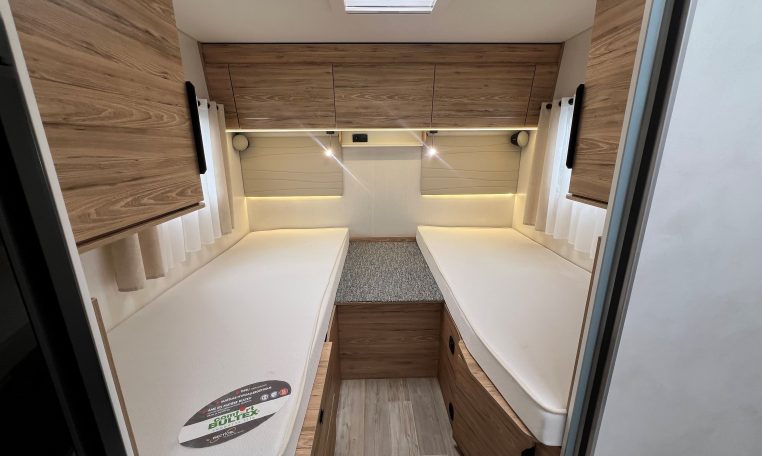 2025 Pilote 650GJ motorhome bedroom with twin single beds, central walkway and overhead storage for a spacious, comfortable layout.