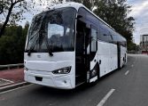 Exterior view of a BCI Volvo B13R Cruiser bus passenger entry door used for boarding and exiting.
