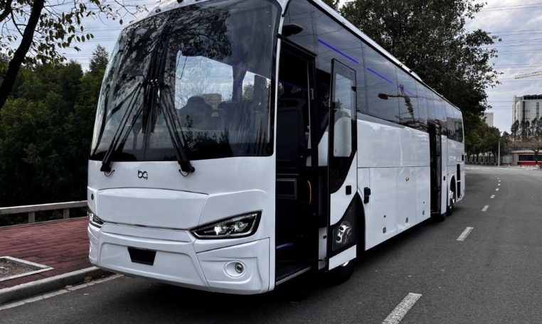 Exterior view of a BCI Volvo B13R Cruiser bus passenger entry door used for boarding and exiting.