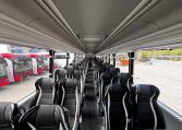 Passenger seats inside a BCI Volvo B13R Cruiser bus arranged in rows along the aisle.