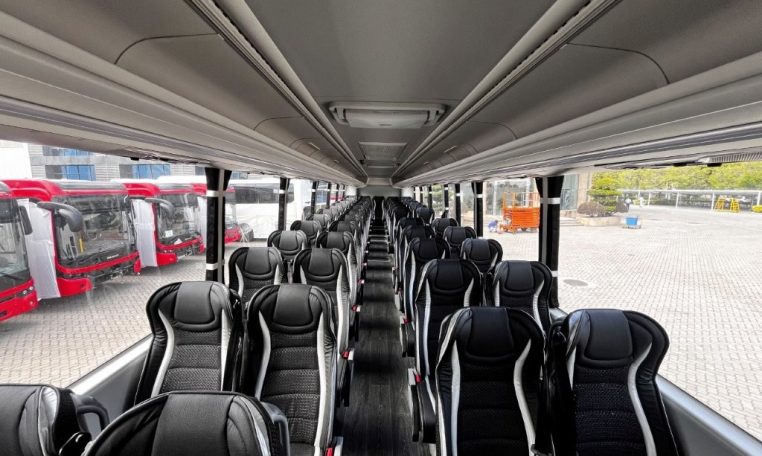 Passenger seats inside a BCI Volvo B13R Cruiser bus arranged in rows along the aisle.