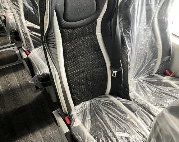 Passenger seats inside a BCI Volvo B13R Cruiser bus arranged in rows along the aisle.